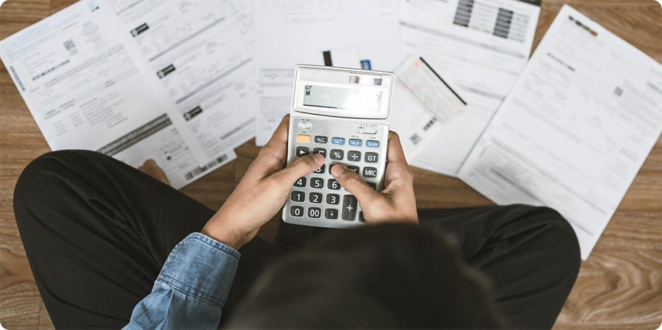 A borrower calculating her monthly bills before applying for a loan with a licensed money lender in Singapore