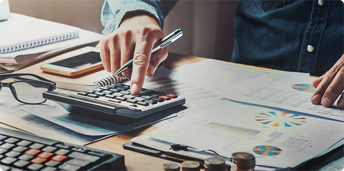 A borrower tallies his debts before engaging an online money lender in Singapore for a loan